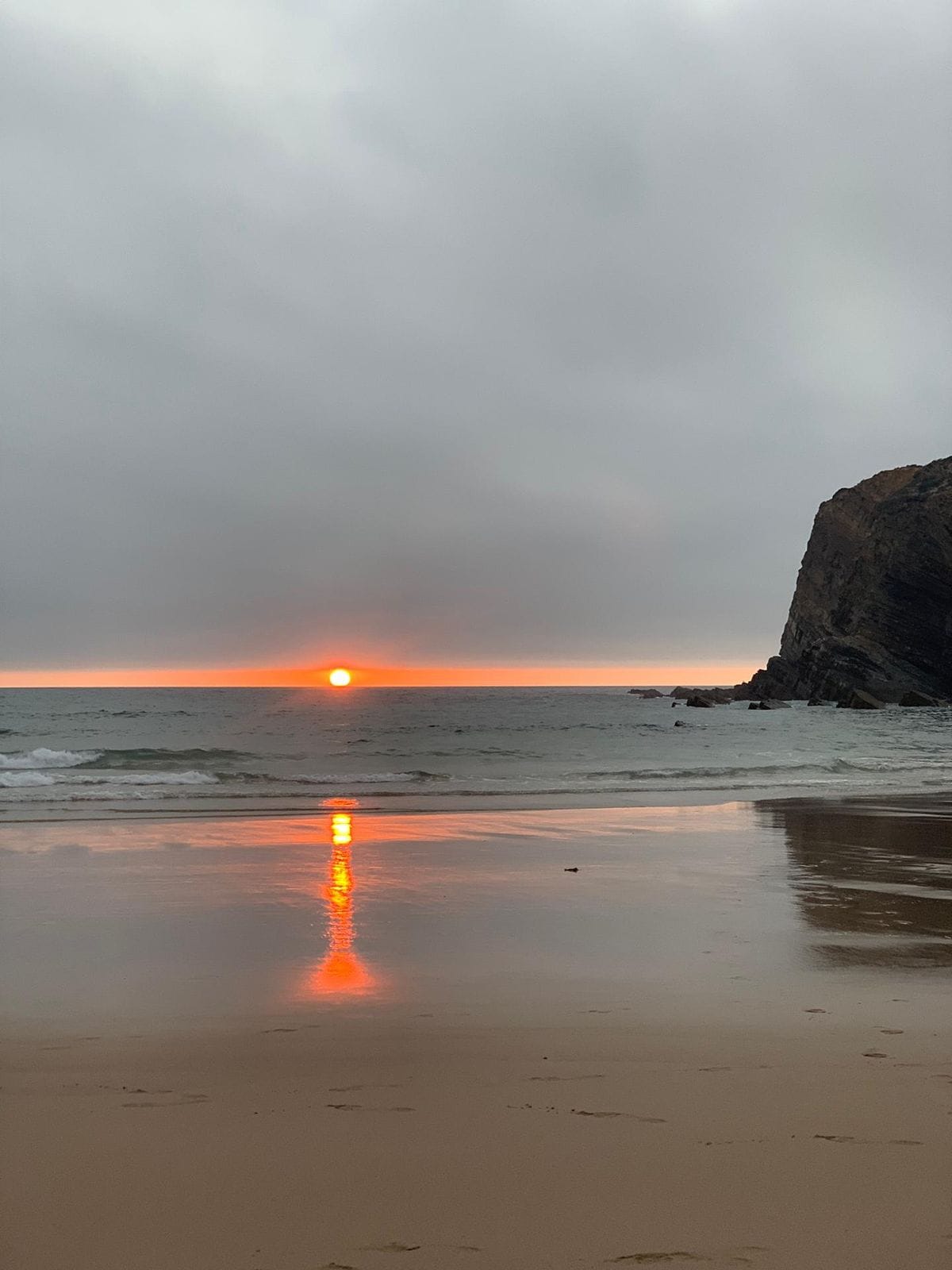 Sunset reflected on wet sand at an Alentejo beach