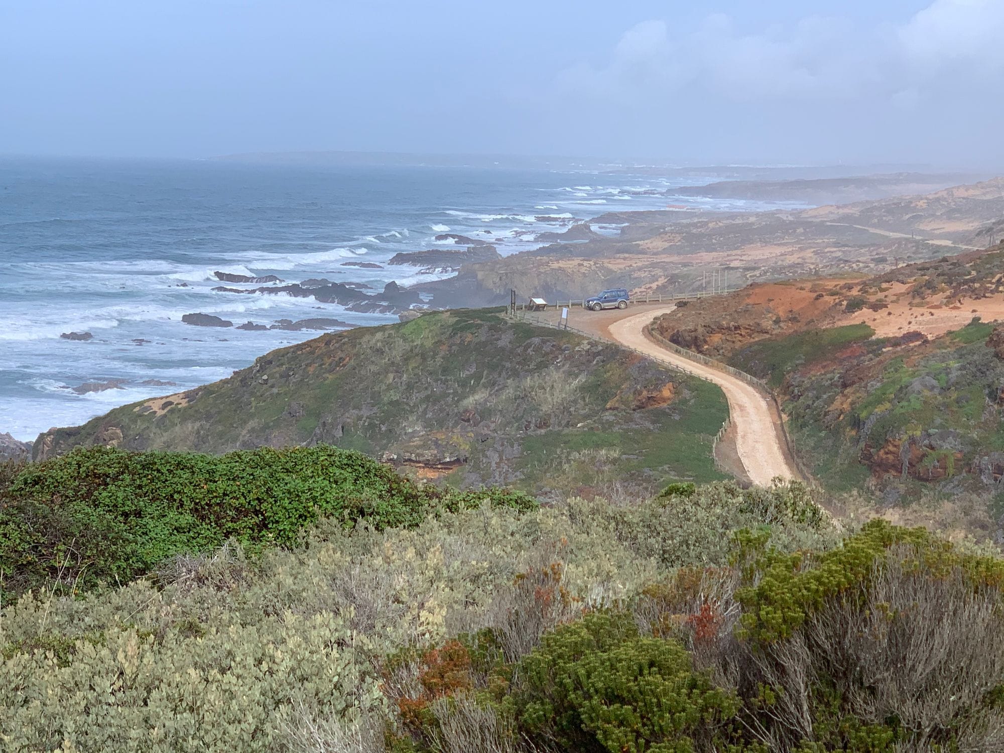 Dirt road winding along the wild Alentejo coast