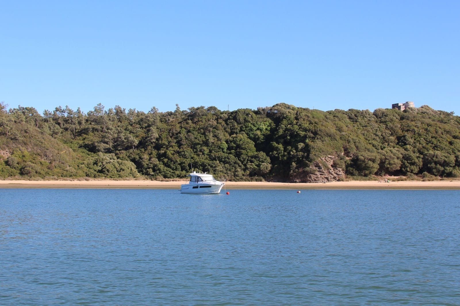 Boat moored off a sandy bank of the Mira