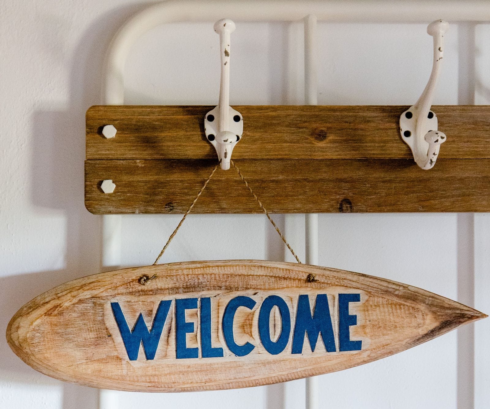Wooden welcome sign hanging in a Nature Bliss home